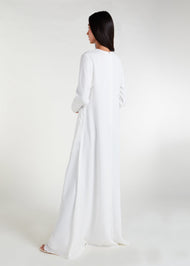 Long Line Abaya in Classic White, featuring a flattering silhouette that effortlessly complements your style. Experience comfort and sophistication in every step with this must-have addition to your modest collection.