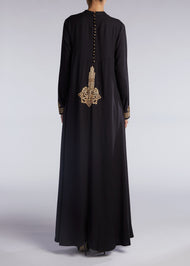 This simple yet elegant abaya features embroidery on the back and cuffs. Inspired by Islamic Art of Calligraphy. 'Celi' Is the name of a pen used for large forms of calligraphy. Black.