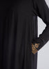 This simple yet elegant abaya features embroidery on the back and cuffs. Inspired by Islamic Art of Calligraphy. 'Celi' Is the name of a pen used for large forms of calligraphy. Black.