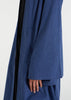 Waist pleats create a flowy silhouette, accompanied by wide sleeves and a stylish kimono style. The denim blue color adds to its overall appeal, while pockets provide functionality.