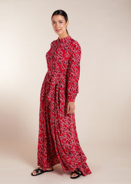 Elevate your style with the vibrant floral maxi, designed with a front button opening and discreet side pockets. The lightweight fabric provides a chic look from day to night, while the slim fit at the top and loose-fit sleeve with cuffs create a flowy skirt effect from the waist down.