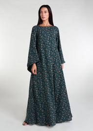 The Kew Maxi Dress is a lightweight and flowy maxi dress, complete with bell sleeves. Its vibrant green color and delicate floral print make it the perfect choice for a breezy summer day. 