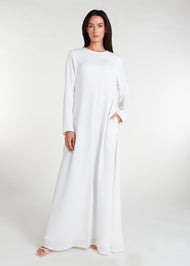  Long Line Abaya in Classic White, featuring a flattering silhouette that effortlessly complements your style. Experience comfort and sophistication in every step with this must-have addition to your modest collection.