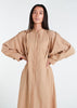 This Maxi Shirt Dress Sand features cuffed sleeves and pockets, giving the appearance of a tucked-in shirt and skirt when it is actually a one-piece outfit. Pleats at the waist create a cinch, while the top half remains loose for a comfortable fit. The dress is cut in an A-line style. Neutral beige tone.