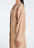 This Maxi Shirt Dress Sand features cuffed sleeves and pockets, giving the appearance of a tucked-in shirt and skirt when it is actually a one-piece outfit. Pleats at the waist create a cinch, while the top half remains loose for a comfortable fit. The dress is cut in an A-line style. Neutral beige tone.