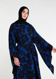 Elevate your evening and garden party attire with the striking Midnight Rose Kaftan, featuring a bold black and blue rose print. Designed with fully lined, dramatic pointed wide sleeves, this kaftan is perfect for special occasions. 