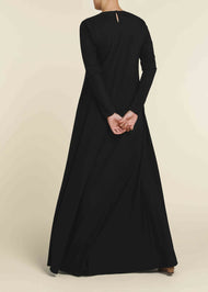 Black colour. Cut in 100% cotton jersey with a fitted bodice & voluminous drop. Styling details include a round neckline with subtle pleats. Features button fastenings on the back & sleeve cuffs.&nbsp;