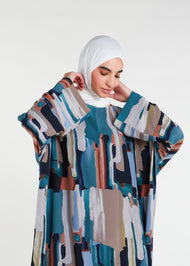 This print Kaftan boasts a full lining, side slits for ease of movement, and a free-flowing design that is ideal for the summer season. For a snugger fit, choose a size down as the Kaftan is designed to be loose-fitting. Paint brush splashes in multicolour, vertical.