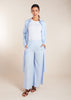 The Sky Blue Co-Ord Set features a light cotton feel and includes loose fit flared trousers paired with a long shirt. This versatile set allows for both open and closed styling, making it the perfect outfit for summer. To ensure a seamless look, we recommend wearing nude undergarments or a vest underneath, as light cotton fabrics tend to be sheer.