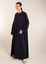 This elegant Two Piece Open Abaya set includes a Full Sleeve matching inner dress. Perfect for everyday wear, it can also be dressed up with accessories for an evening look. The open abaya can be worn as a maxi on its own or paired with the inner dress for a stylish ensemble. In navy.